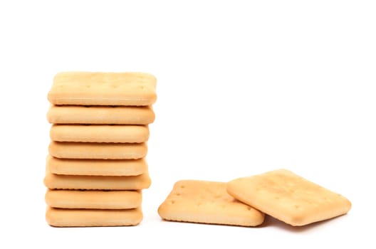 Stack of saltine soda crackers isolated on white