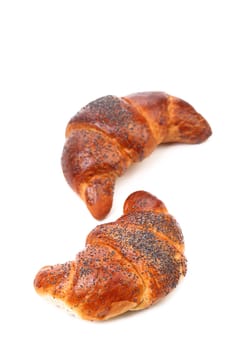 Appetizing croissants with poppy. Close up. White background.