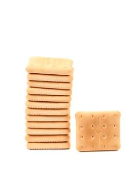 Stack of saltine soda crackers isolated on white