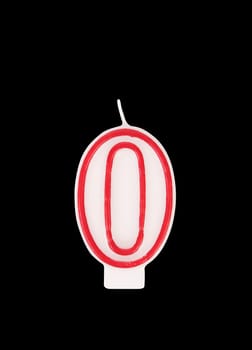 Candle in the form of nil figures. Black background.