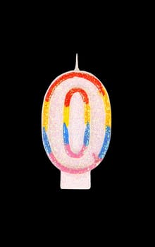 Candle in the form of nil figures. Black background.