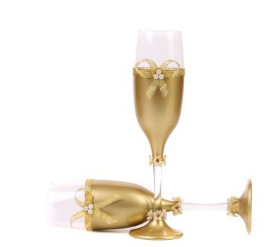 Decorated wedding golden glasses wuth bow. White background.