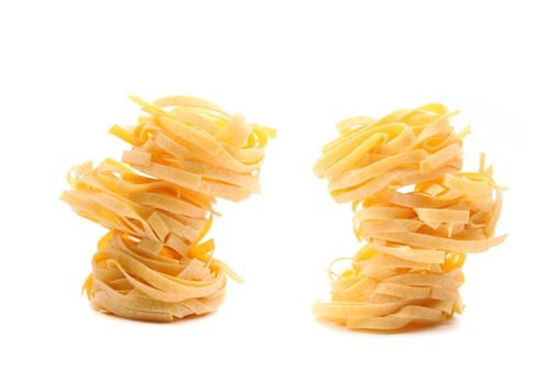 Tagliatelle paglia e fieno homemade tipycal italian pasta close-up on the white background