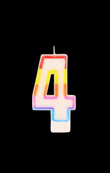 Candle in the form of four figures. Black background.