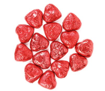 Red chocolate hearts candies on a white background
