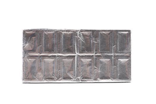 Chocolate bar wrapped in foil. White background.