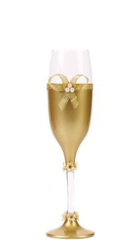 Decorated wedding golden glass wuth bow. White background.