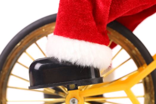 Wheel of bicycle, black boot and red leg. White background.