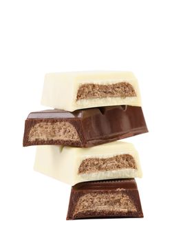 Stack of black and white chocolate bar with filling. White background.