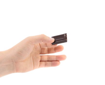 Hand holds chocolate bar. Isolated on a white background.