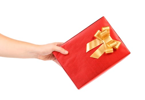 Red present box with spots and golden bow. White background.