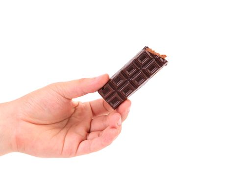 Hand holds chocolate bar with filling. Isolated on a white background.