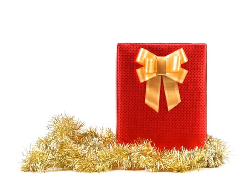 Red present box with spots and golden bow. White background.
