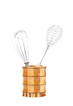Two different whisks in wooden jar. White background.