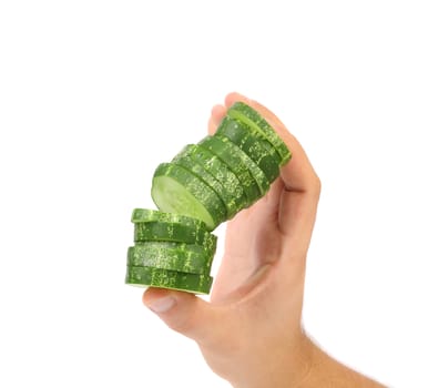 Hand holds stack juicy cucumber on a white background