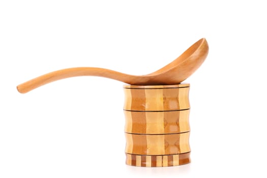 Wooden spoon and jar. Isolated on a white background.