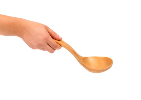 Hand holds wooden spoon. Isolated on a white background.