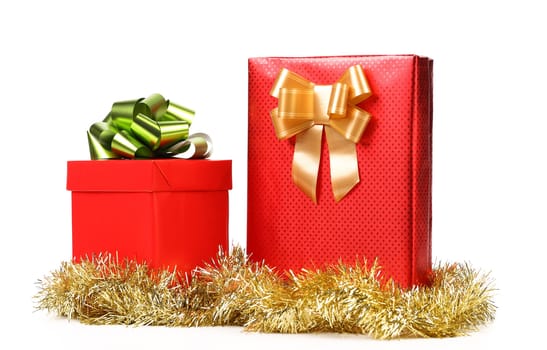 Two red boxes with bows and tinsel. White background.