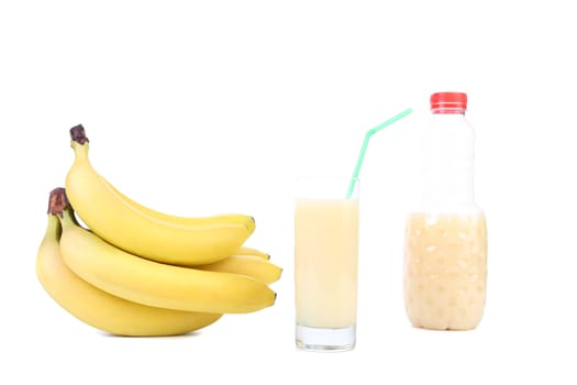 Glass and bottle of juice. Bananas. White background.
