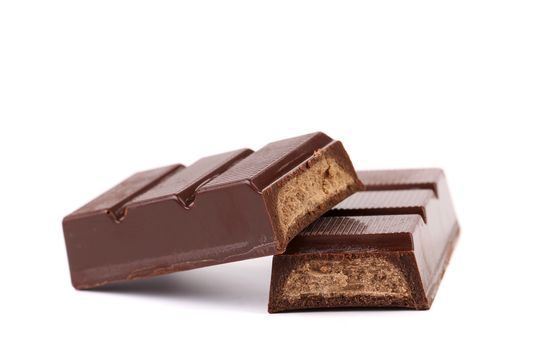 Splitted chocolate sticks with fillihg. White background.