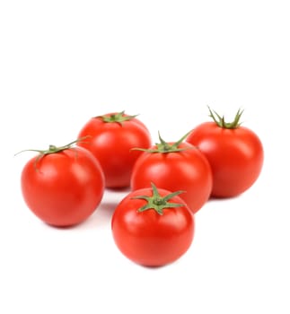 fresh tomatoes with green leaves isolated on white background