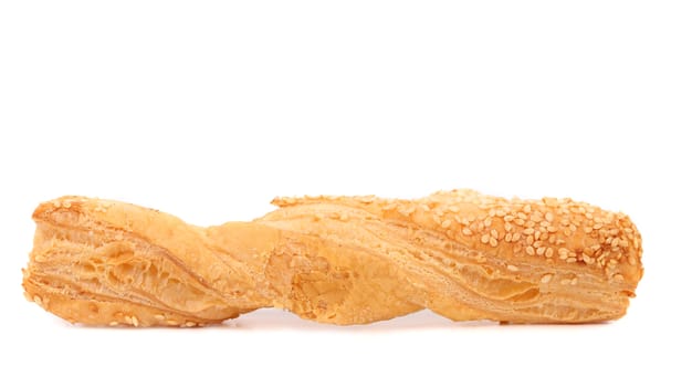 Just baked crunchy puff pastry with sesame. White background.