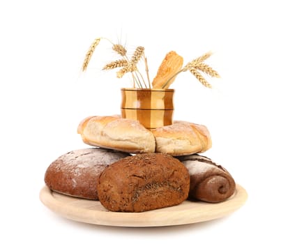 Different breads. Jar and tray of wood. Ears. White background.