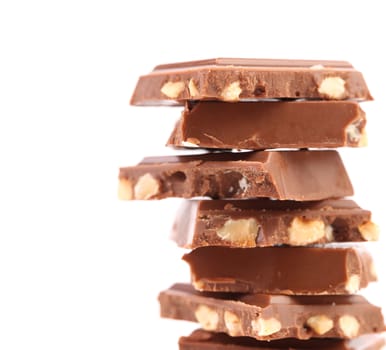 Stack of milk chocolate bar with nuts isolated on white background