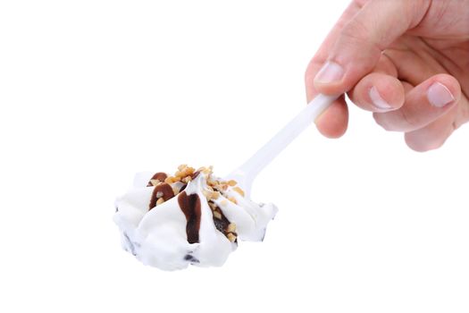 Hand holds ice cream on a spoon. White background.