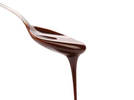 chocolate syrup leaking from spoon on white background with clipping path