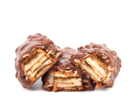 Broken chocolate bars with filling. White background.