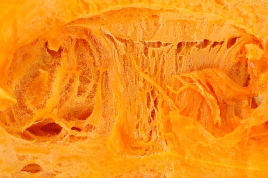 Background of pumpkin slice. Macro. White background.