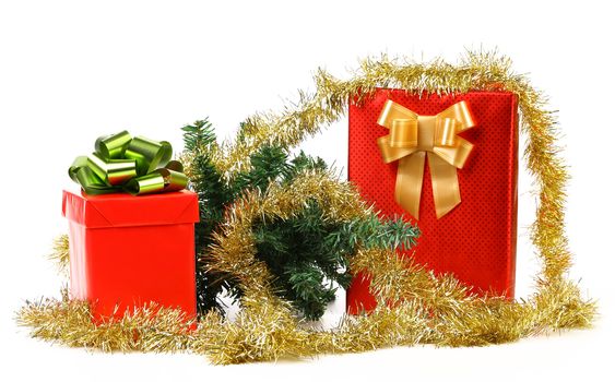 Gift boxes with Christmas tree and tinsel. White background.