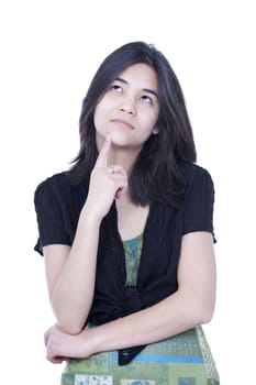 Young teen girl looking up, thinking, finger to chin