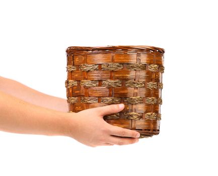 Hand holds basket. Isolated on a white background.