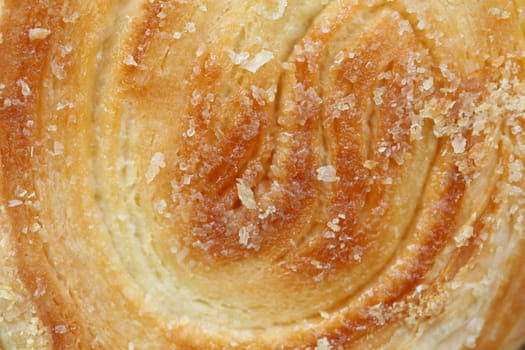 Background of puff pastry with sugar. Close up.