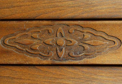 Ornament on old wooden furniture. Close up.