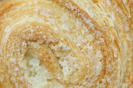 Background of puff pastry with sugar. Close up.