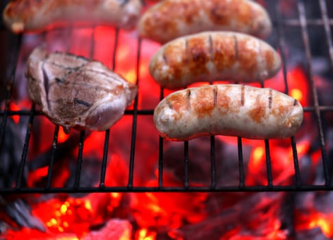 Meat and sausages on BBQ. Whole background.