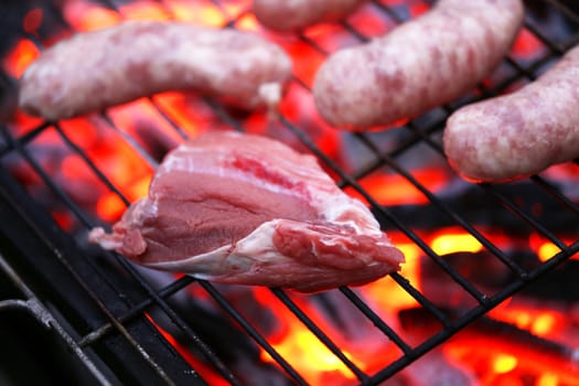 Raw meat and sausages on BBQ. Whole background.