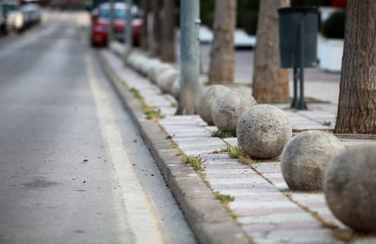 decorative fence of granite balls on a city street