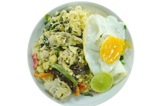 top view stir fried  instant noodles with pork ,  chili , vegetable , slices lime and fried egg  on dish over  white background