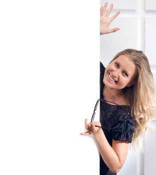 Beautiful woman holding a blank billboard on light background