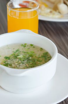 Rice soup with mince pork and vegetable and orange juice