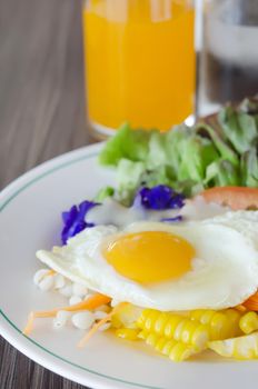 fried egg and fresh salad on dish  for breakfast 