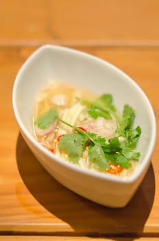 close up  spicy green mango salad  in white bowl , asian food