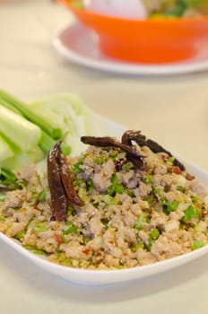 close up asian dish , spicy minced pork eaten with  fresh vegetable