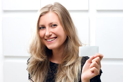 Portrait of smiling business woman giving blank business card