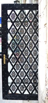 Glass door with eastern pattern with rhombus, vertical photo