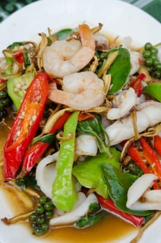 top view  fried  shrimp and squid with herbal vegetable on white dish